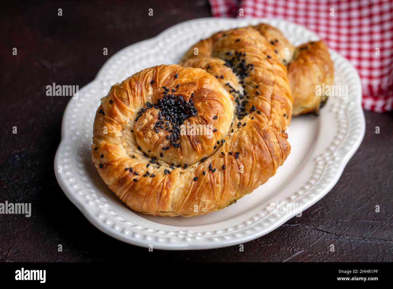 Traditional delicious Turkish phyllo stuffed with spinach, cheese (Turkish name; Gul borek or gul boregi) Rose shaped pastry. Stock Photo