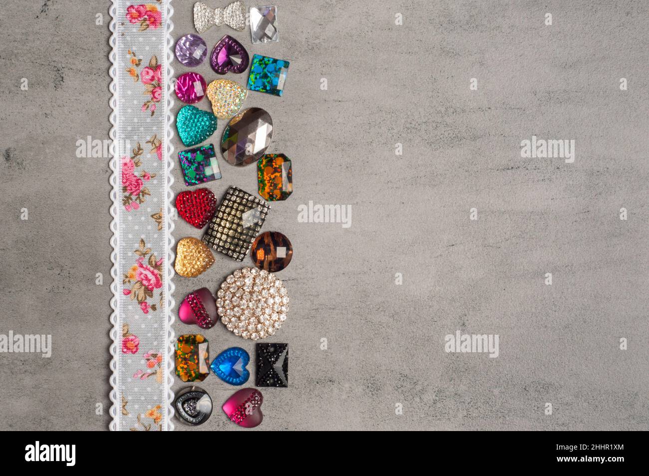 multi-colored sewn stones on a grey background.Copy Space Stock Photo