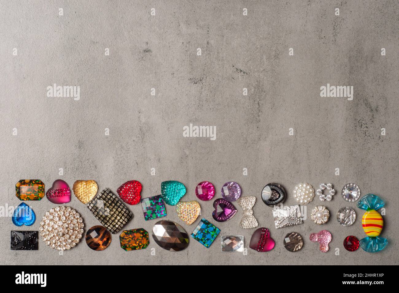 multi-colored sewn stones on a grey background.Copy Space Stock Photo
