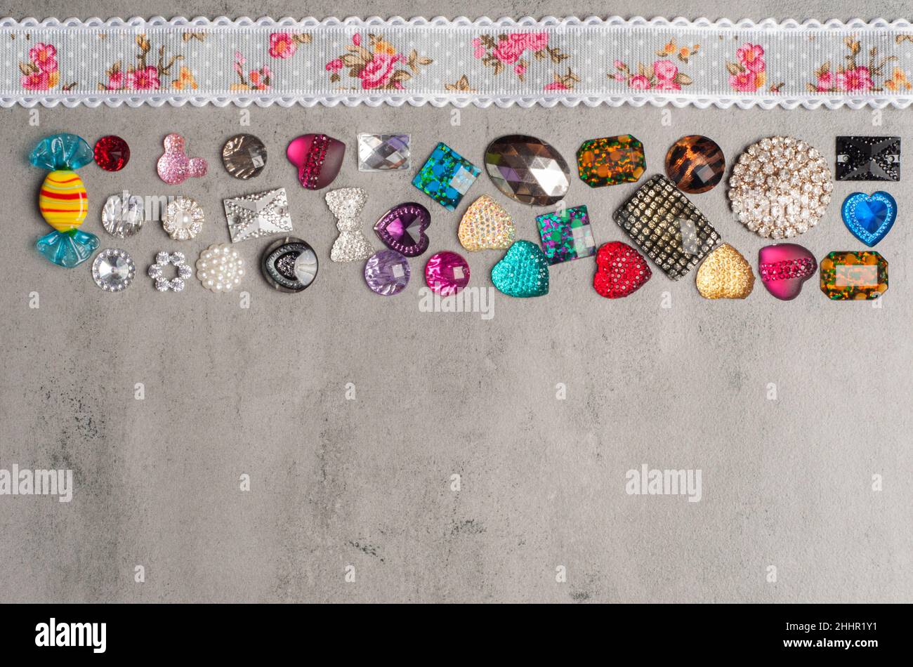 multi-colored sewn stones on a grey background.Copy Space Stock Photo