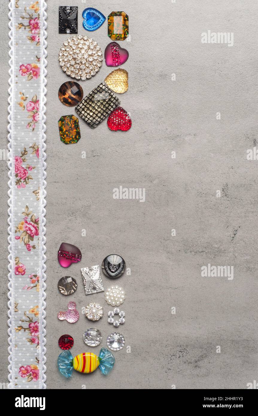 multi-colored sewn stones on a grey background.Copy Space Stock Photo