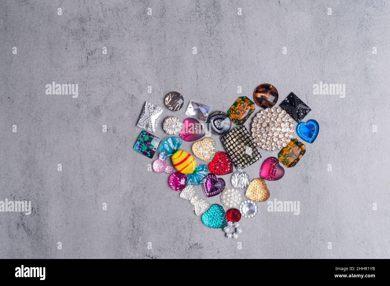 multi-colored sewn stones on a grey background.Copy Space Stock Photo