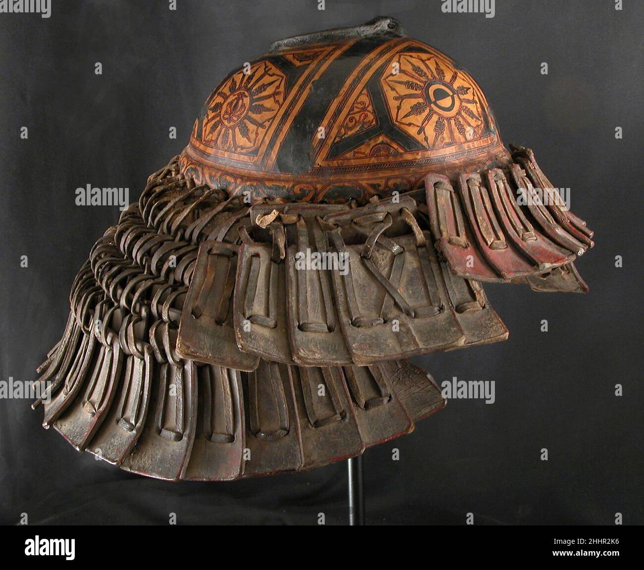 Helmet possibly 17th century Yi or Nuosu people (Lolo) The Nuosu (also formerly known as Lolo) are part of the Yi peoples and have lived in mountainous sections of southwestern China, covering parts of Sichuan, eastern Yunnan, and Guizhou provinces, for approximately the past one thousand years. Arts and crafts flourished in traditional Nuosu culture, including weaving, embroidery, silversmithing, and lacquerwork. Notable among the lacquerwork is Nuosu armor, which is made of lacquered leather in a style that is unique to the region and can be recognized by its form, construction, and decorati Stock Photo