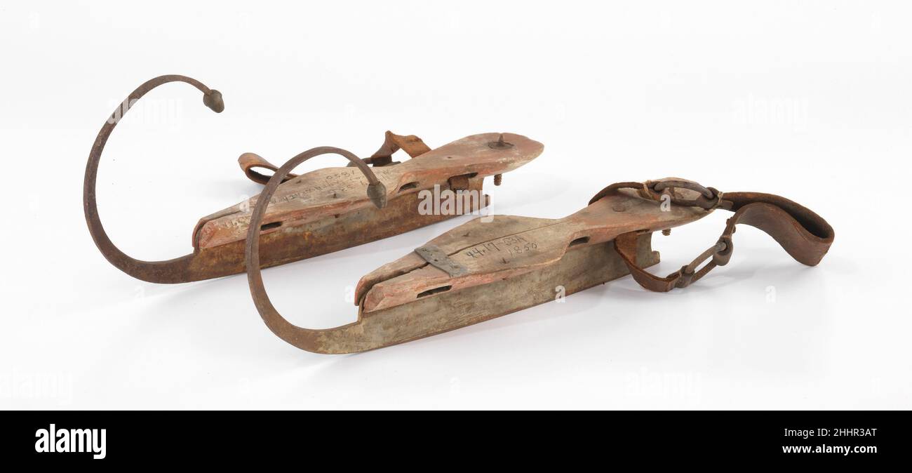 Ice skates 1840–59 American Ice skating, a well established winter pastime in northern Europe for centuries, became a craze in the United States in the 1850s and 1860s. This pair of ice skates from early in that period is as visually delightful as they are functional. The wooden foot bed is carved in an attractively slender and deeply waisted shape, and the whimsical blade is terminated by an amusing acorn tip. Basic skate design changed little in the 400-some years since the Dutch had introduced sharpened metal blades, which allowed the skater to push off with the foot instead of using long p Stock Photo