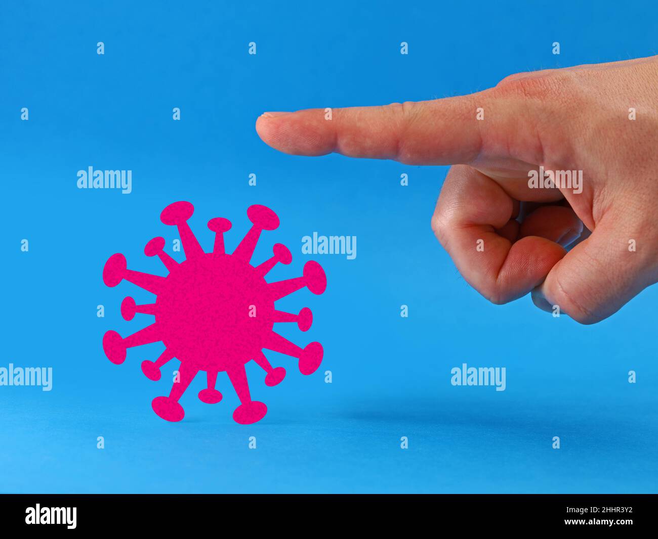 finger shows corona virus the way isolated on blue background, good bye pandemic concept image Stock Photo