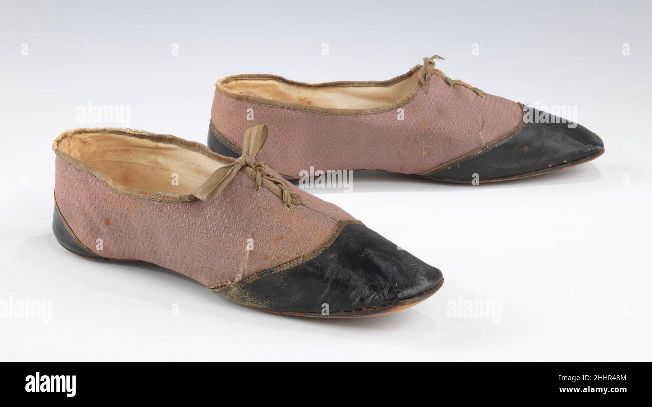 Shoes 1840–49 American While fancy evening shoes were saved in abundance, surviving day shoes are relatively scarce. The leather tip and foxing of these tie shoes was a common style for daywear in the 1840s, and renders an otherwise flimsy and thin shoe more serviceable. The self-patterned cotton provides an interesting textural contrast with the leather. Neutral colors such as tan, brown, and the dull mauve seen here, were favored at the time.. Shoes  156322 Stock Photo