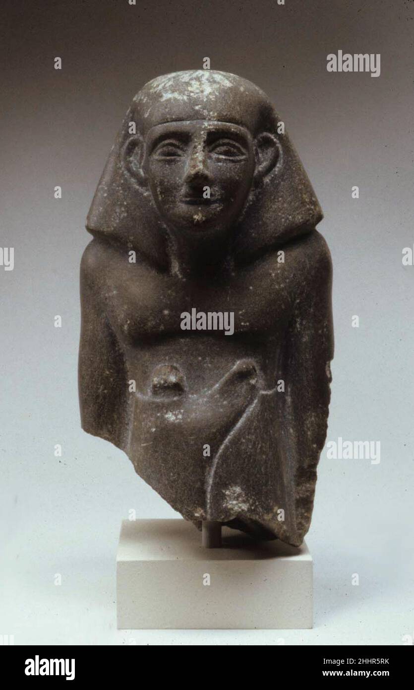 Statuette of Senbi in long kilt ca. 1802–1640 B.C. Middle Kingdom. Statuette of Senbi in long kilt. ca. 1802–1640 B.C.. Schist. Middle Kingdom. From Egypt, Memphite Region, Lisht North, cemetery south of pyramid south of House A1:4, Pit 898, MMA excavations, 1920–21. Dynasty 12–13 Stock Photo