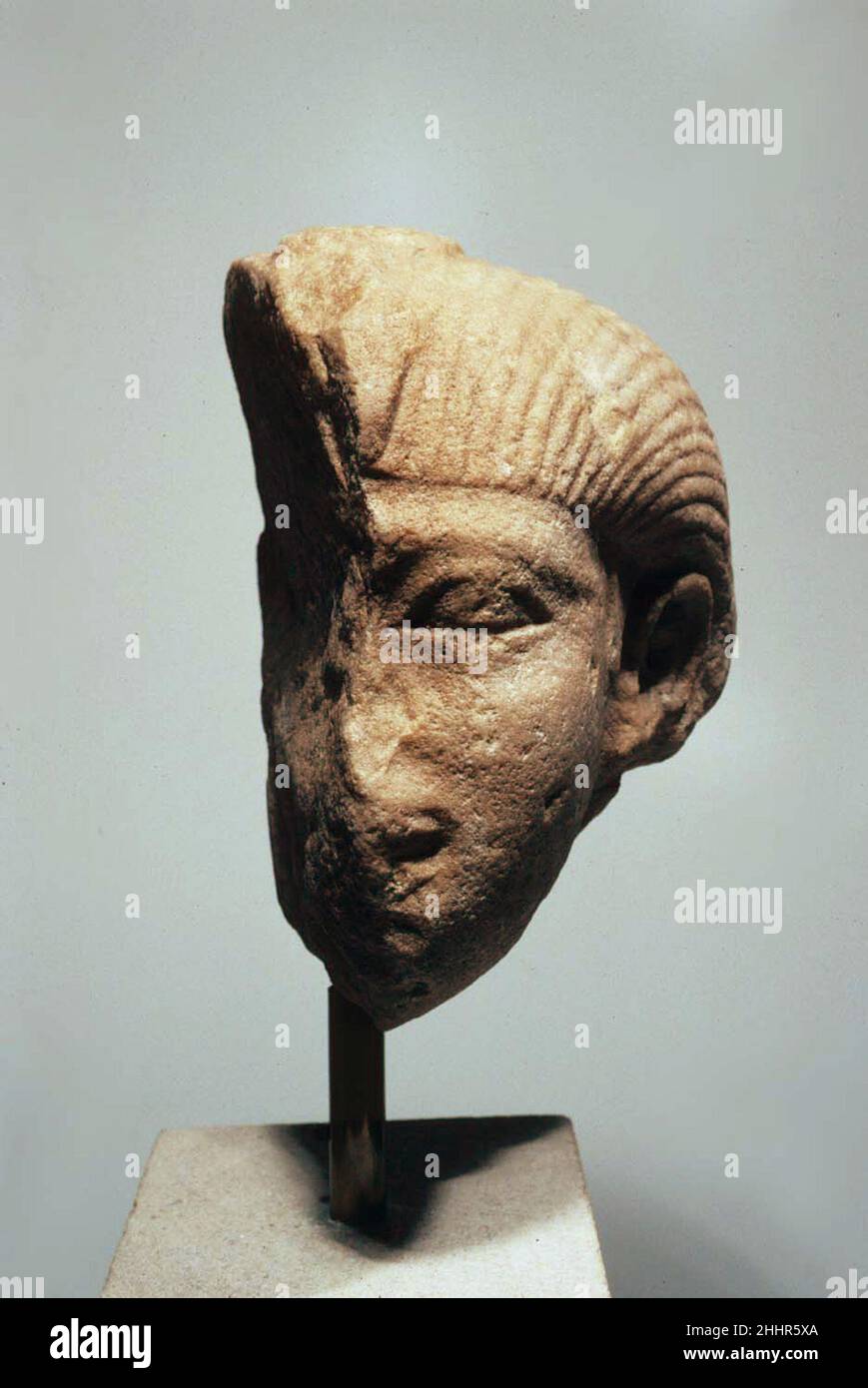 Head of a Sphinx ca. 1981–1878 B.C. Middle Kingdom The uraeus serpent marks the royal status of this person, who is wearing an unusual wig with striations running from the forehead to the back. The statue depicts part of the real hair projecting from underneath the wig, in front of the ear. Looking at the head itself, it seems unclear if a man or woman is depicted. The shape of the mouth and the several tight curls of the uraeus fit well to early dynasty 12, but the naturally sculpted eyebrow and ear point towards the middle of this dynasty. The facial features do not match any king of this pe Stock Photo