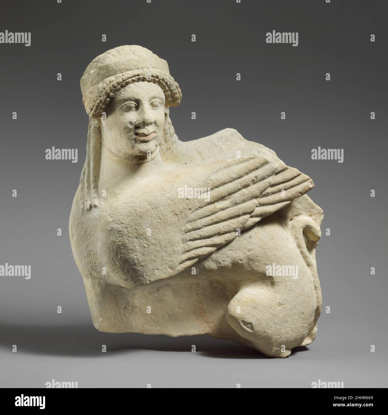 Fragment of a limestone funerary stele with a seated sphinx middle of the 5th century B.C. Cypriot Sphinx with earrings and necklaces.. Fragment of a limestone funerary stele with a seated sphinx  242148 Stock Photo