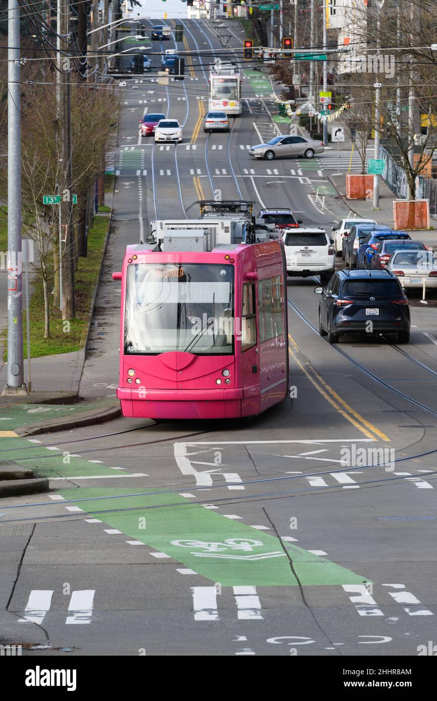 Seattle - January 22, 2022; Washington State Hot Pink colored Seattle streetcar passing along Yesler Way with service on the First Hill Line Stock Photo