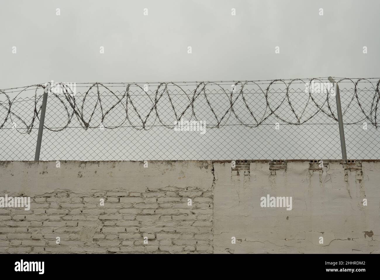 barbed wire on a concrete wall Stock Photo