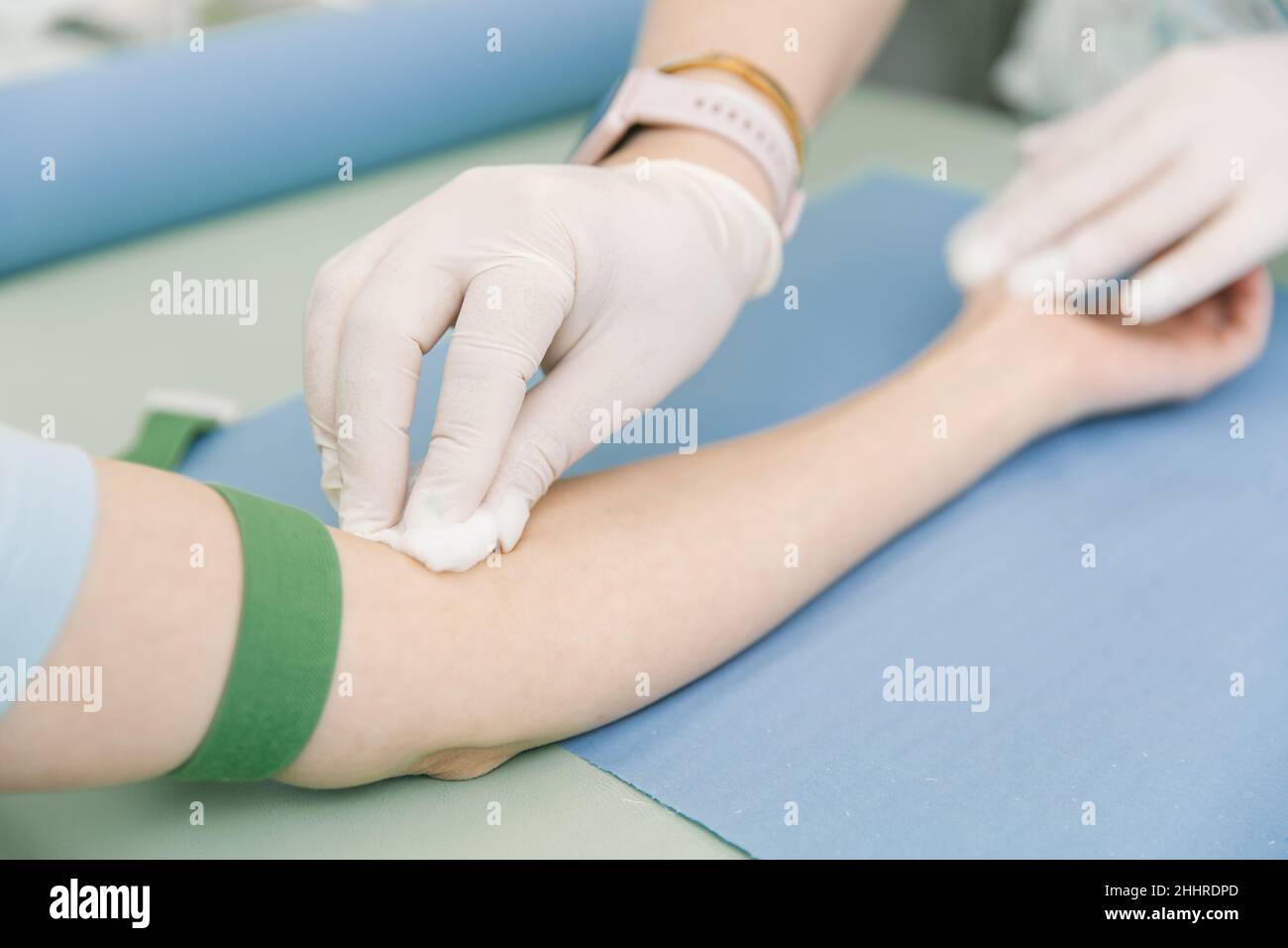Taking A Blood Test From A Vein In The Treatment Room Nurse Pricking A taking-a-blood-test-from-a-vein-in-the-treatment-room-nurse-pricking-a