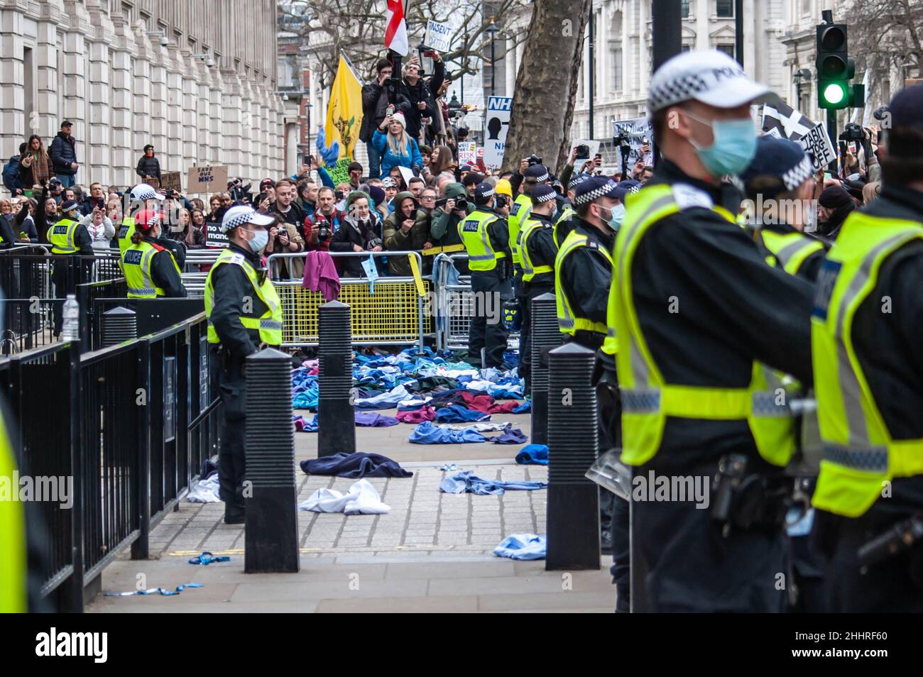 LONDON, ENGLAND- 22 January 2022: NHS uniforms thrown towards downing street at the NHS100K protest against vaccine mandates Stock Photo