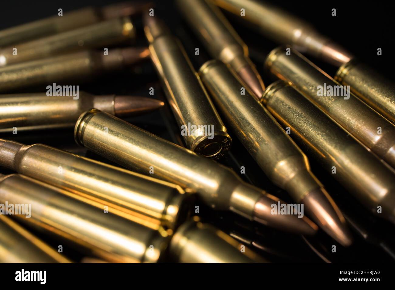pile of .223 5.56x45 rifle bullets. Automatic rifle ammo Stock Photo