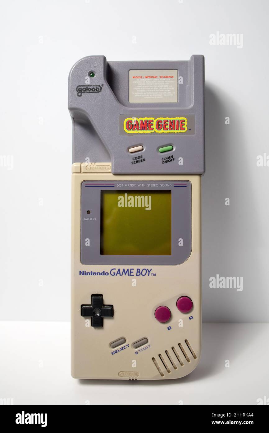 Schiedam, The Netherlands - OCT 4, 2020: Closeup of a retro portable video game console with a cheating device on a white background. Stock Photo