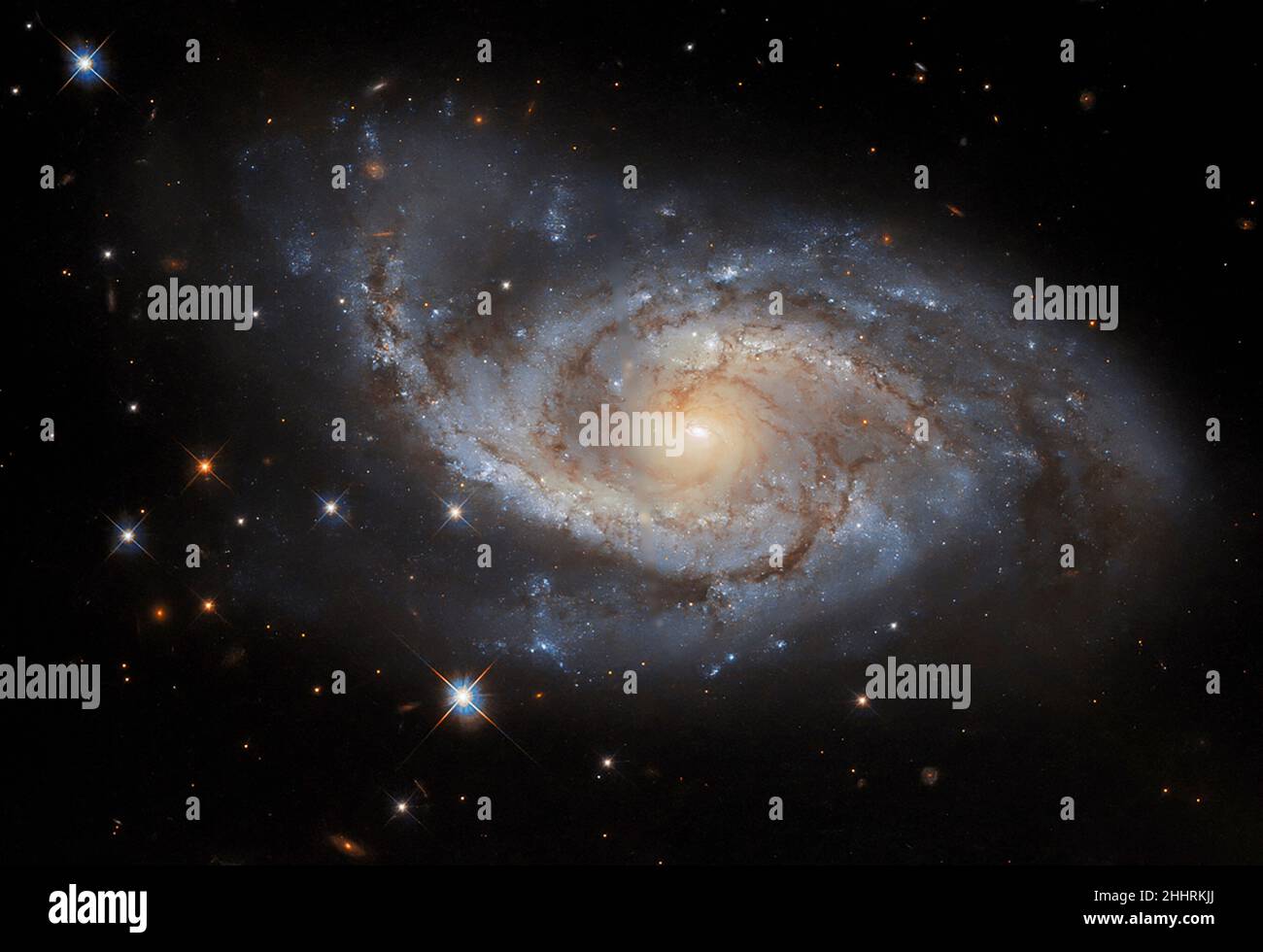 The spiral arms of the galaxy NGC 3318 are lazily draped across this image from the NASA/ESA Hubble Space Telescope released on January 21, 2022. This spiral galaxy lies in the constellation Vela and is roughly 115 million light-years away from Earth. Vela was originally part of a far larger constellation, known as Argo Navis after the fabled ship Argo from Greek mythology, but this unwieldy constellation proved to be impractically large. Argo Navis was split into three separate parts called Carina, Puppis, and Vela â each named after part of the Argo. As befits a galaxy in a nautically insp Stock Photo