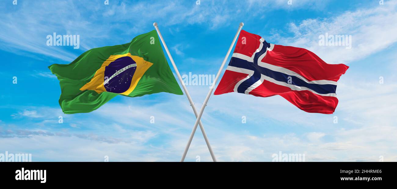 crossed national flags of Brazil and Norway flag waving in the wind at ...
