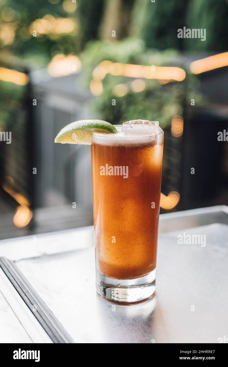 https://c8.alamy.com/comp/2HHRRE7/tamarind-whiskey-sour-cocktail-on-ice-with-lime-2HHRRE7.jpg