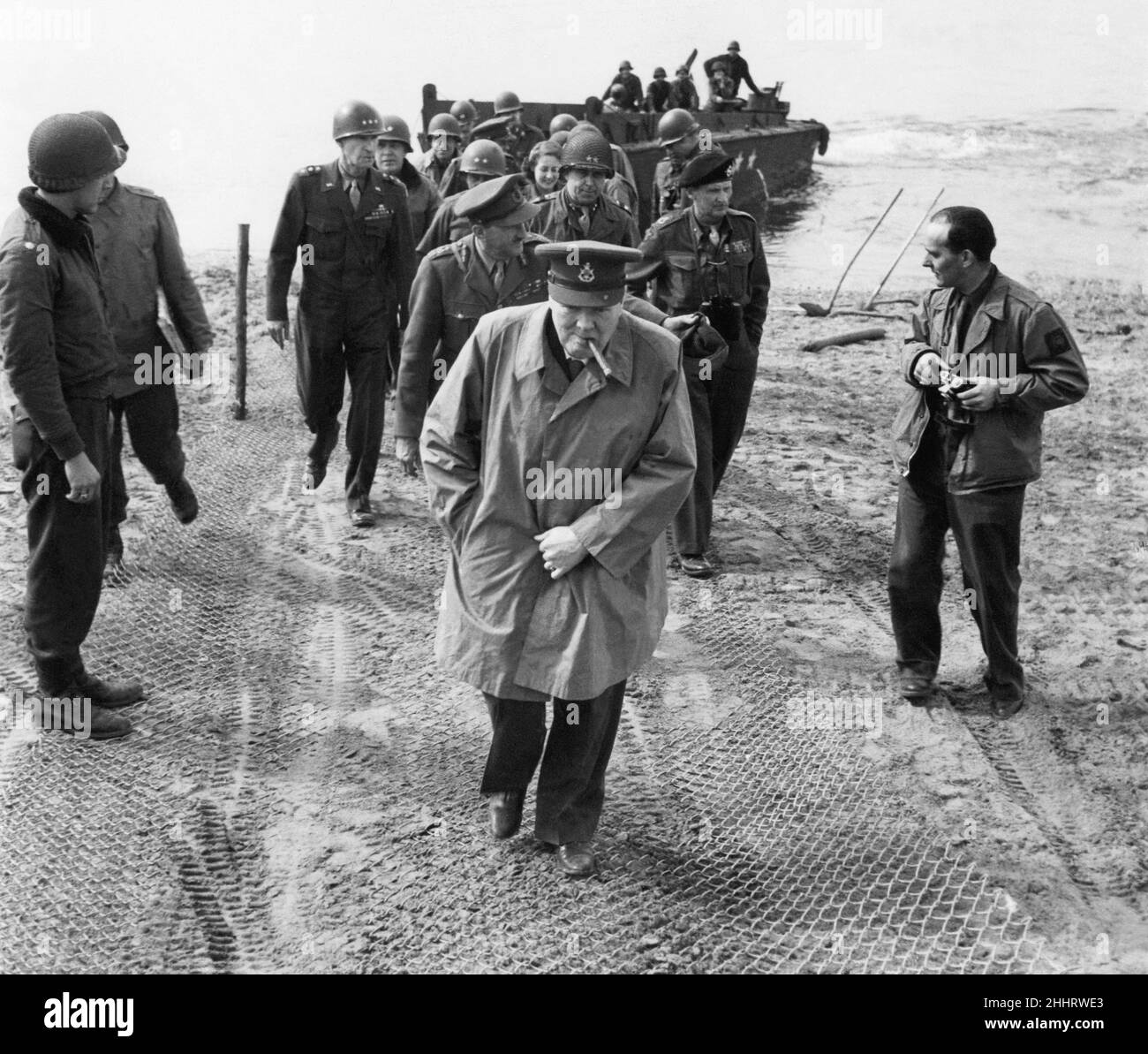 British Prime Minister Winston Churchill and Field Marshall Bernard Montgomery cross the Rhine.  On March 25th Mr. Churchill with Field Marshall Montgomery crossed to the East bank of the Rhine in an American L.C.U.P. Picture shows: The Prime Minister and party walking up the bank after stepping ashore. 26th March 1945. Stock Photo
