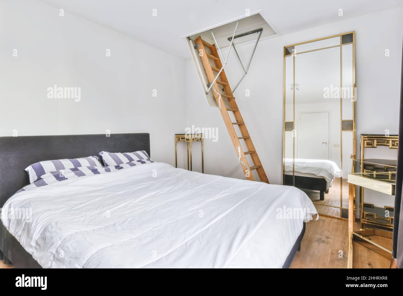 Modern bedroom with the stairs access to upper attic Stock Photo Alamy