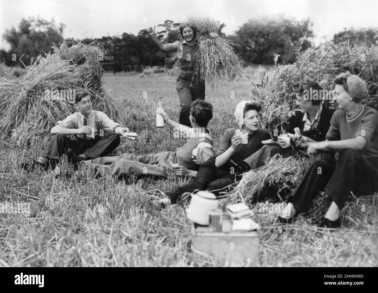 A group of friends enjoy a picnic out in the countryside during their farm holiday at the end of the Second World War.29th July 1945. Stock Photo