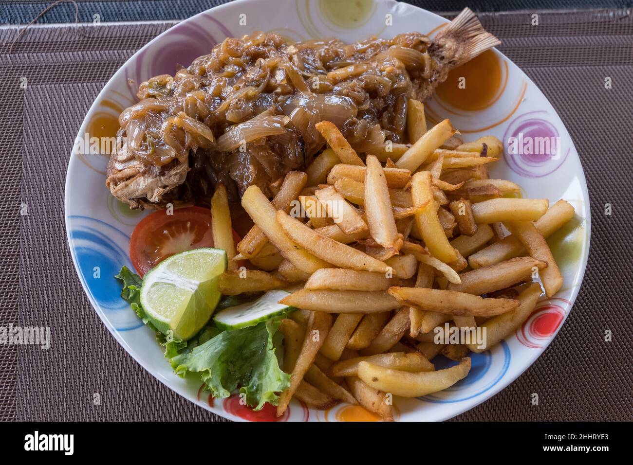 Fish with onion sauce and chips Stock Photo Alamy