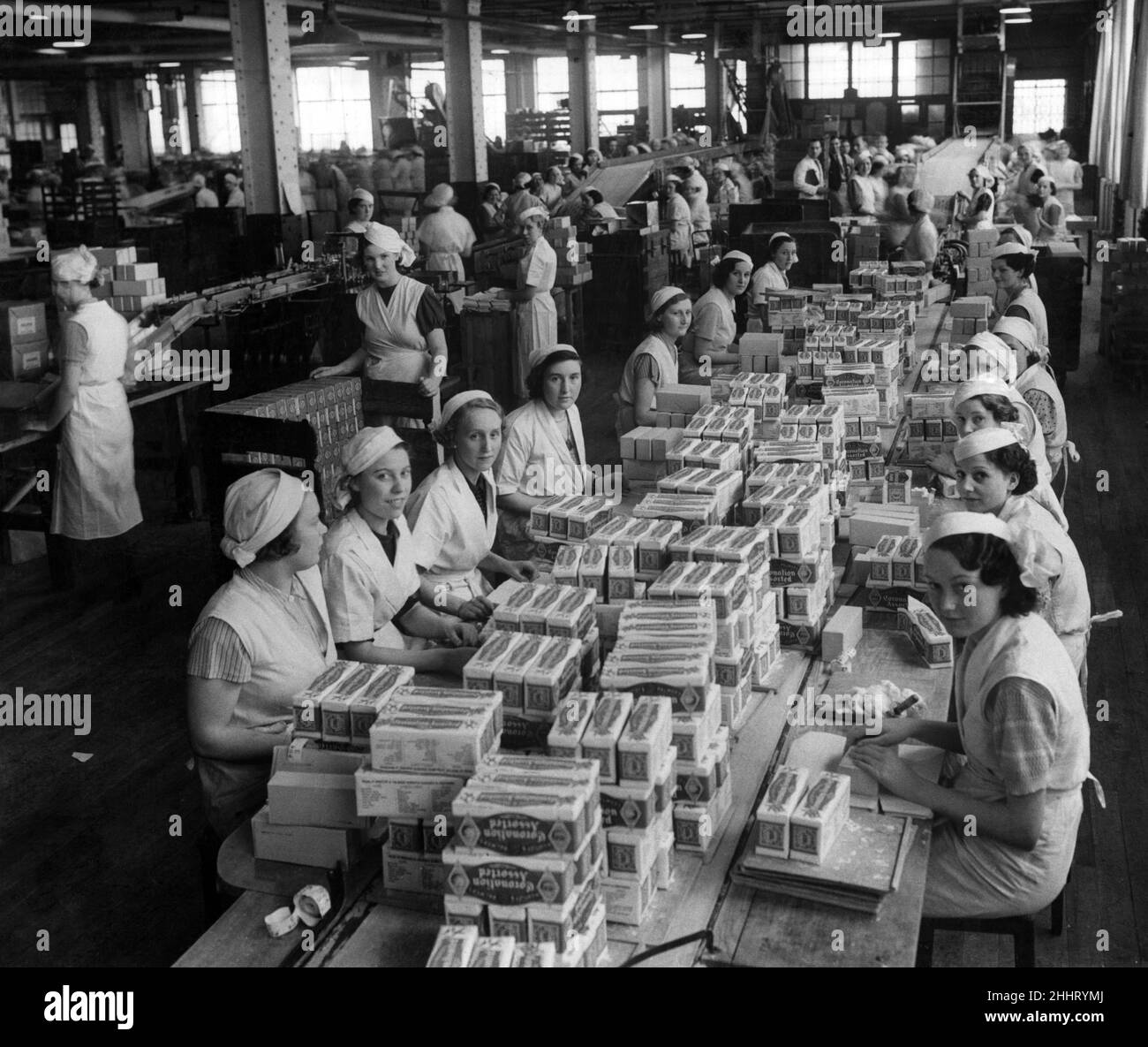 The interior of Huntley & Palmers factory, women packing cartons of Coronation Assorted biscuits. Reading, 2nd May 1937. Stock Photo