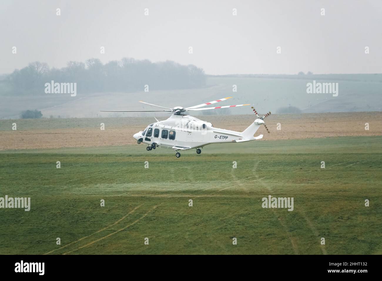 G-ETPP ETPS Agusta AW139 helicopter hovering just above grass on a military pilot training flight exercise, Wiltshire UK Stock Photo