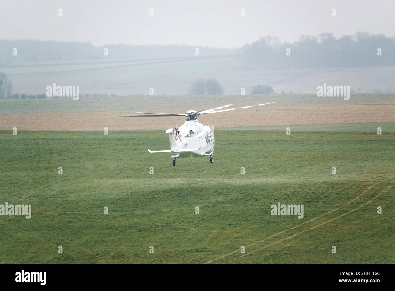 G-ETPP ETPS Agusta AW139 helicopter hovering just above grass on a military pilot training flight exercise, Wiltshire UK Stock Photo