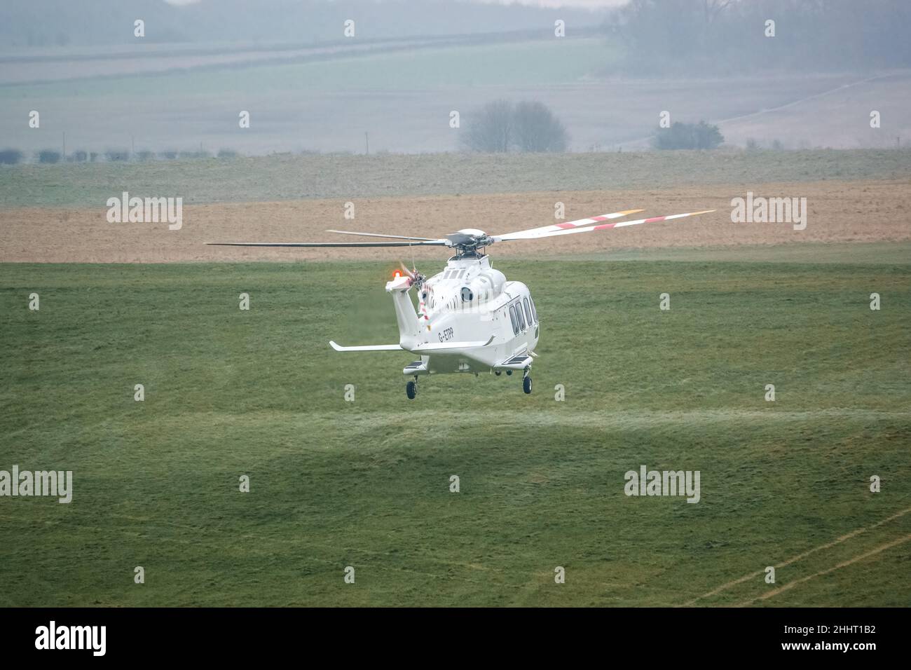 G-ETPP ETPS Agusta AW139 helicopter hovering just above grass on a military pilot training flight exercise, Wiltshire UK Stock Photo