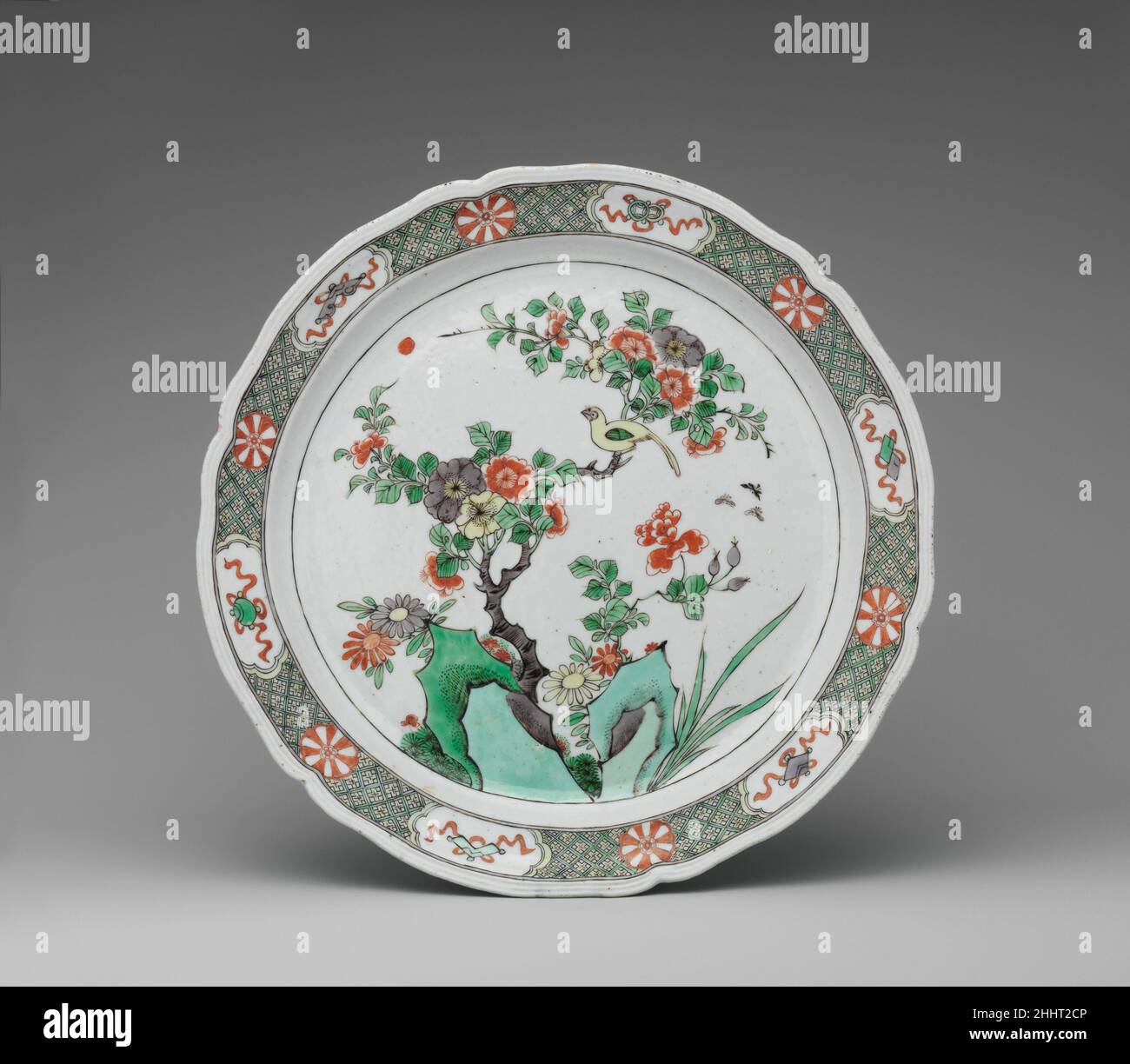 Dish with rocks, flowers, and birds 1725–30 Chinese, for European, probably French, market In addition to the standard motif of rocks, flowers, and birds, several of the Eight Treasures—which originated in Buddhist art but are here employed as general symbols of good fortune—decorate the molded rim of the plate, whose shape was copied from contemporaneous French silver.. Dish with rocks, flowers, and birds  208285 Stock Photo