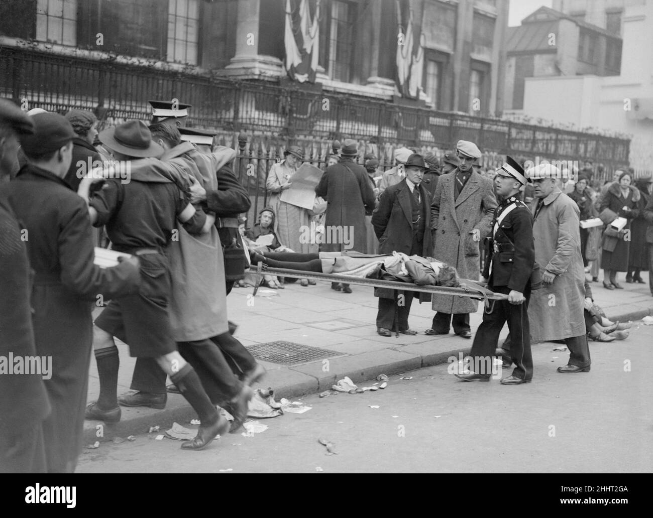 Coronation of King George VI.St Johns Ambulance workers treating injured people in the crowd near Trafalgar Square, awaiting the procession. One woman is carried away on a stretcher for treament.  12th May 1937. Stock Photo