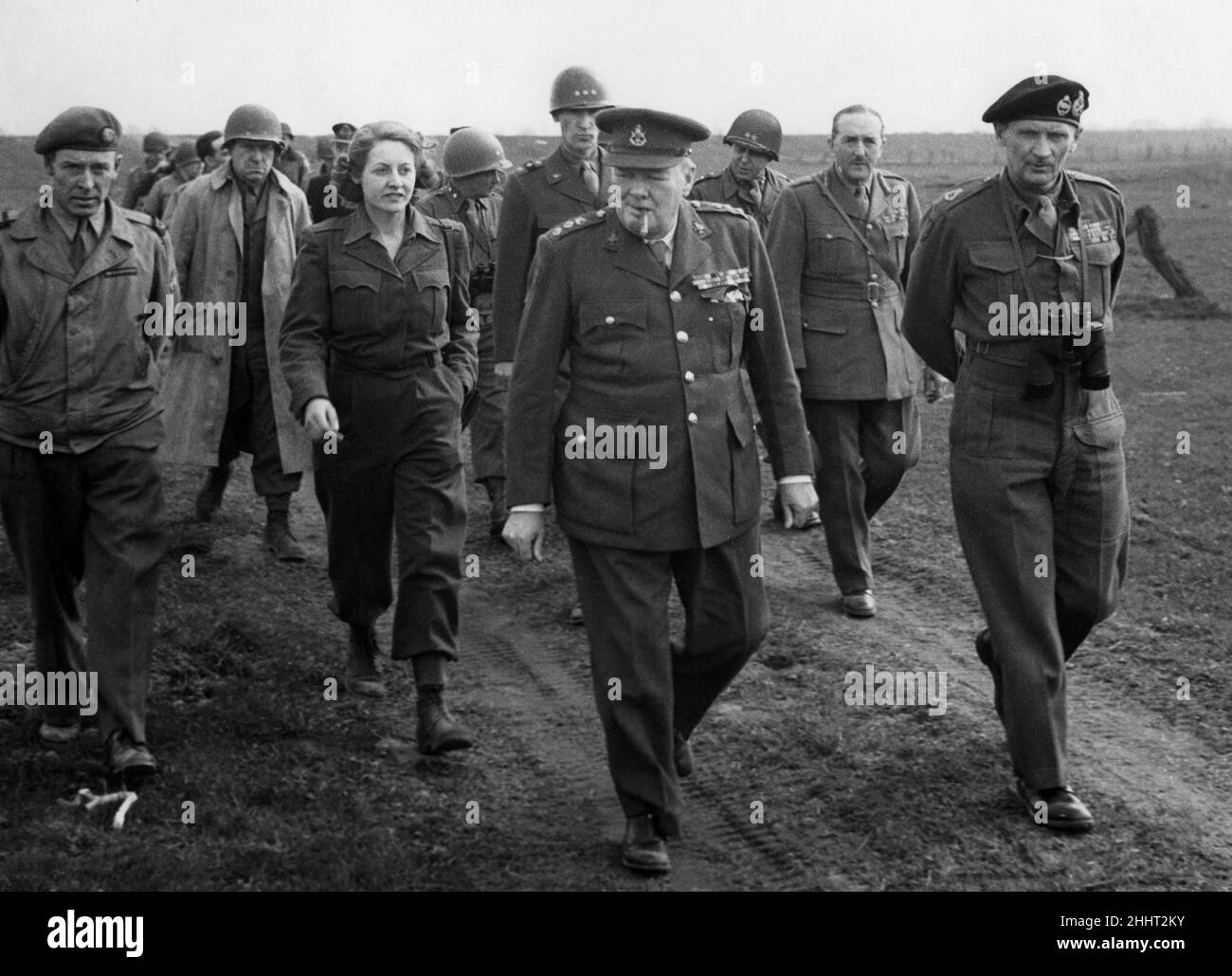 Winston Churchill and Bernard Montgomery cross the Rhine.On March 25th Mr. Churchill with Field Marshal Montgomery crossed the East bank of the Rhine in an American L.C.U.P. Picture shows: The Prime Minister and Field Marshal Montgomery walking along East bank. Beside them iss Rhona Churchill, accredited correspondent for I.N.A. who was the first British woman to cross the Rhine. Her articles appear in the Daily Mail. 26th March 1945. Stock Photo