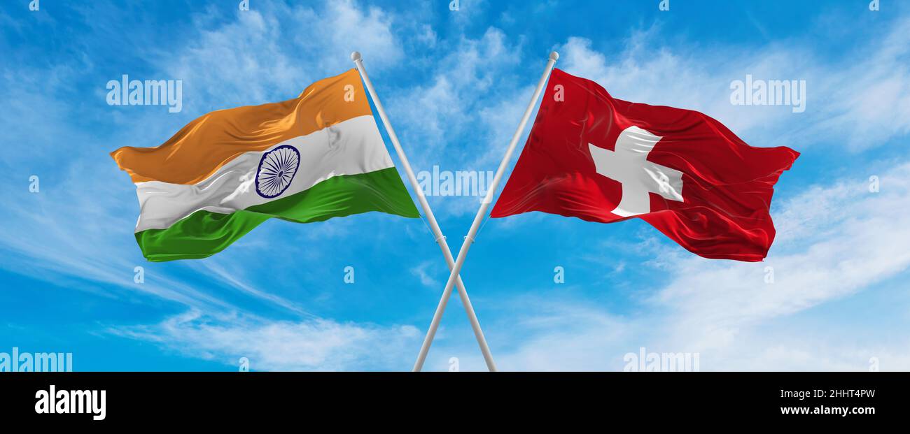crossed national flags of India and switzerland flag waving in the wind ...