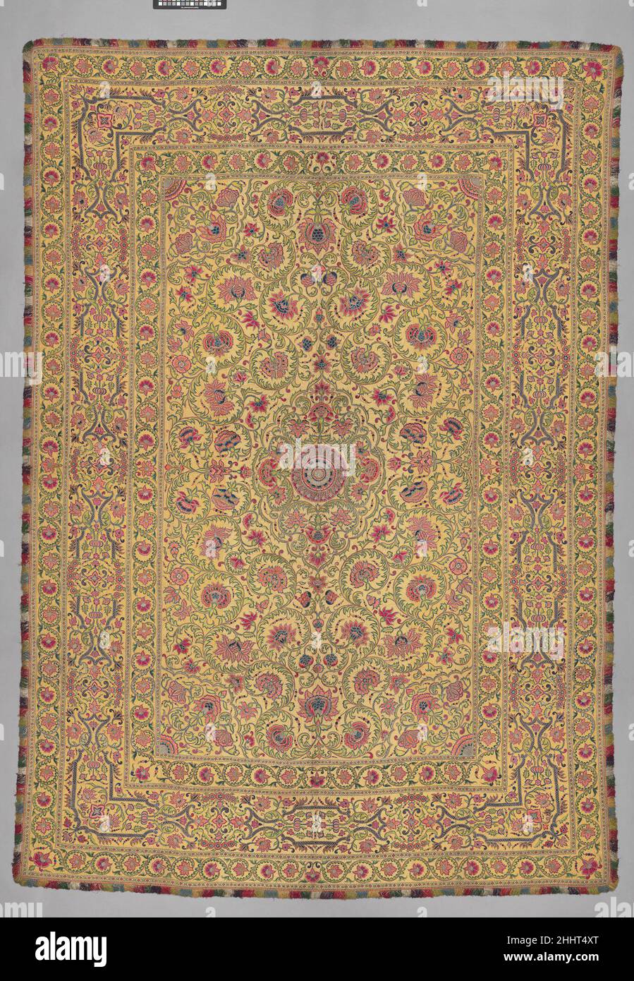 Hanging 16th–17th century Embroidered textiles with central medallions surrounded by flowers and vines were produced in India in the sixteenth through the eighteenth centuries. Because this textile was woven with silver-wrapped thread, it was likely used in a courtly setting, perhaps as a summer carpet or as a cover for the dais (raised platform) of a local ruler. Stylistic and technical similarities to other floor coverings and wall hangings suggest that it may have been produced in the Deccan region during the eighteenth century.Embroidered textiles with central medallions surrounded by flow Stock Photo