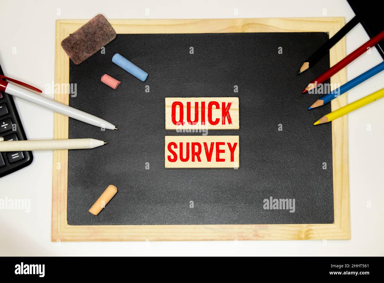 Quick Survey. Speech Bubble on a dark textured wooden background. Stock Photo