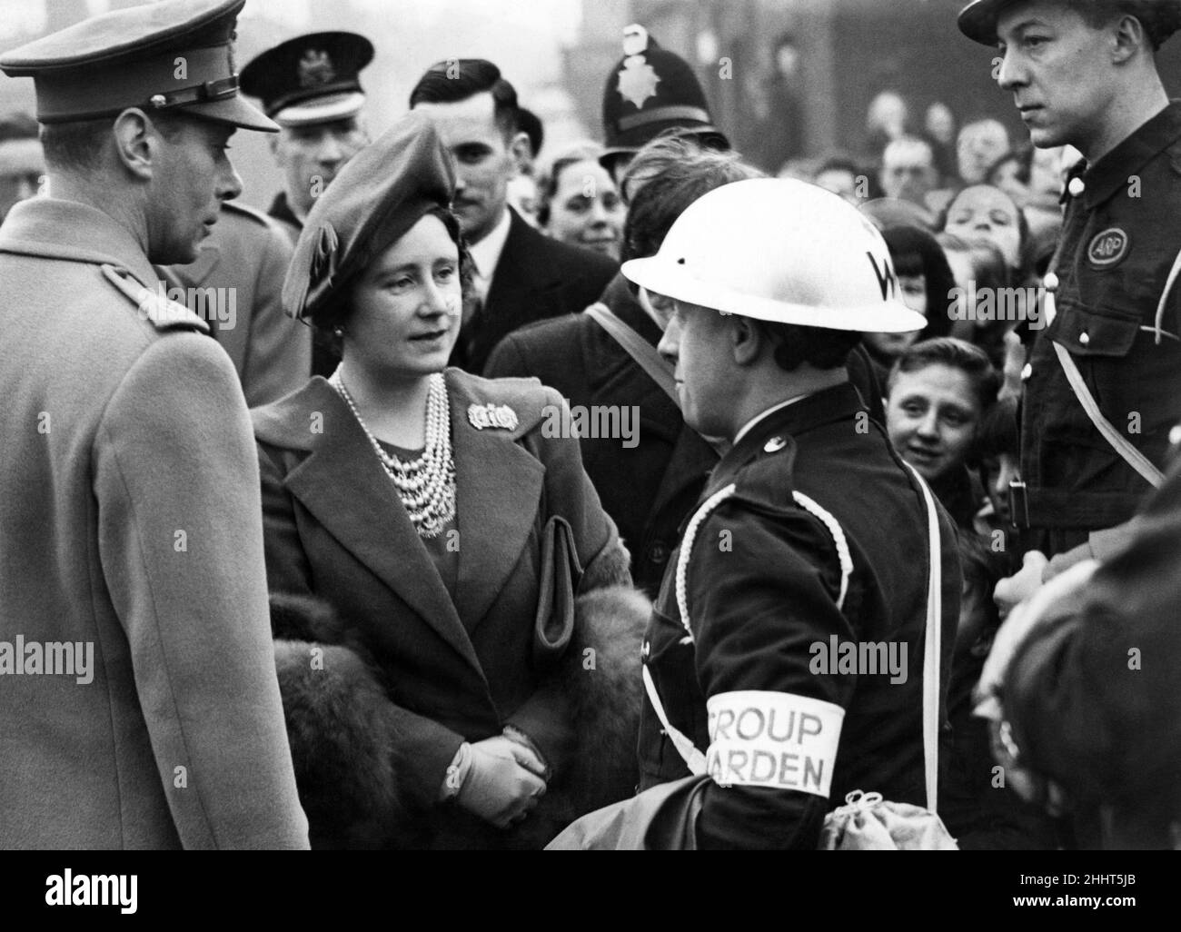 Royal visit to Salford - King George VI & Queen Elizabeth talking to a group warden in Salford. Feb 1941. Stock Photo