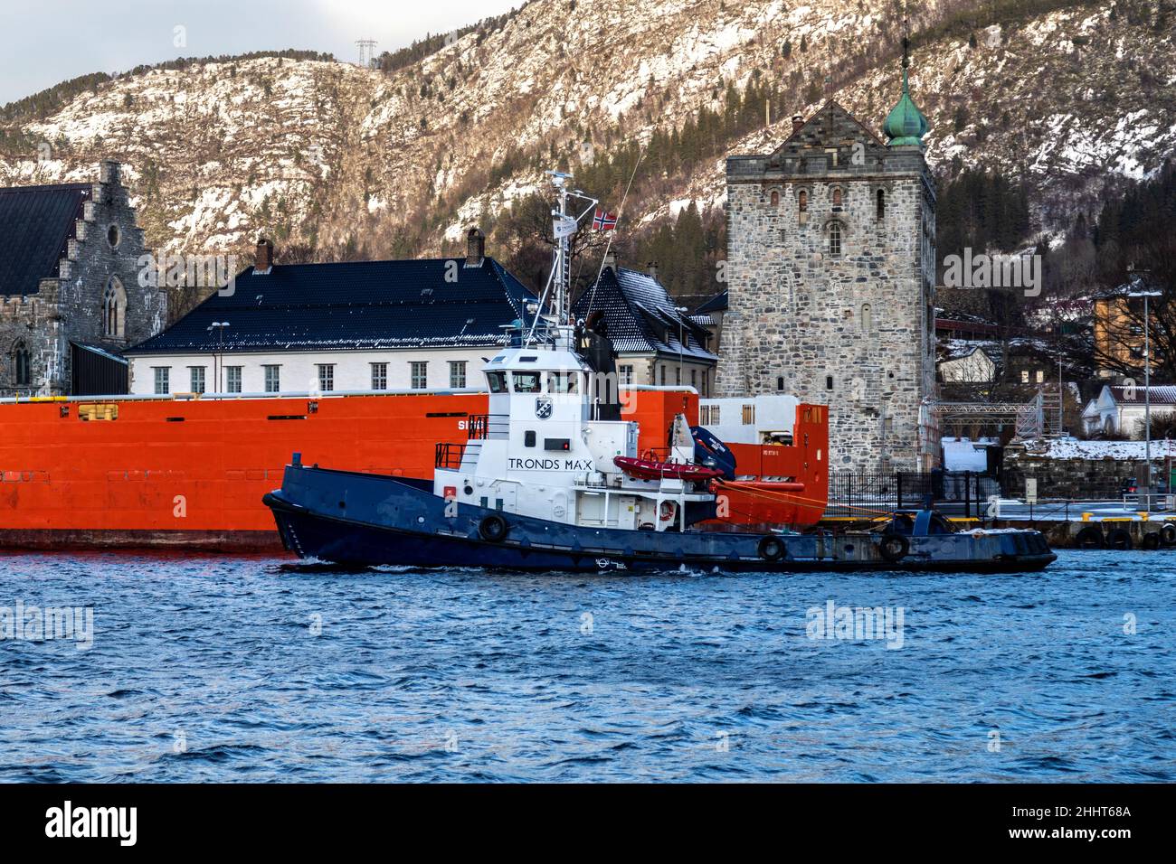 Tug boat Tronds Max departing from the port of Bergen, Norway. Passing the ancient Rosenkrants tower Stock Photo