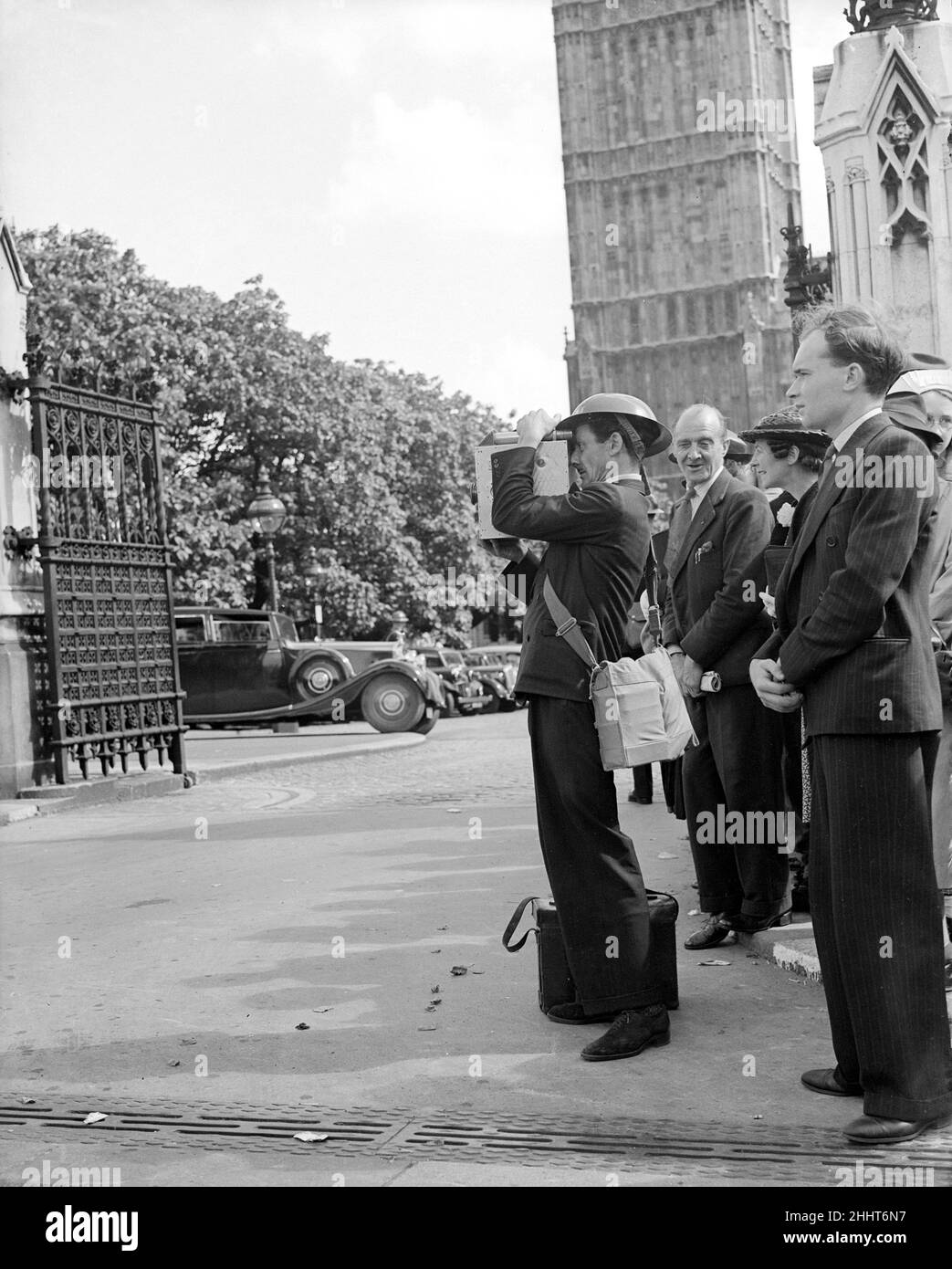 3rd September 1939, Large crowds gathered outside the Houses of Parliament as the zero hour 11am approached which was the time limit for the ultimatum to Germany to expire. Prime Minister Neville Chamberlain announced shortly after 11 that Great Britian had declared war on Germany following the Nazi refusal to retreat from Poland.Our Picture Shows: A news reel cameraman wearing a tin helmet filming the crowds reaction to the declaration of war Stock Photo