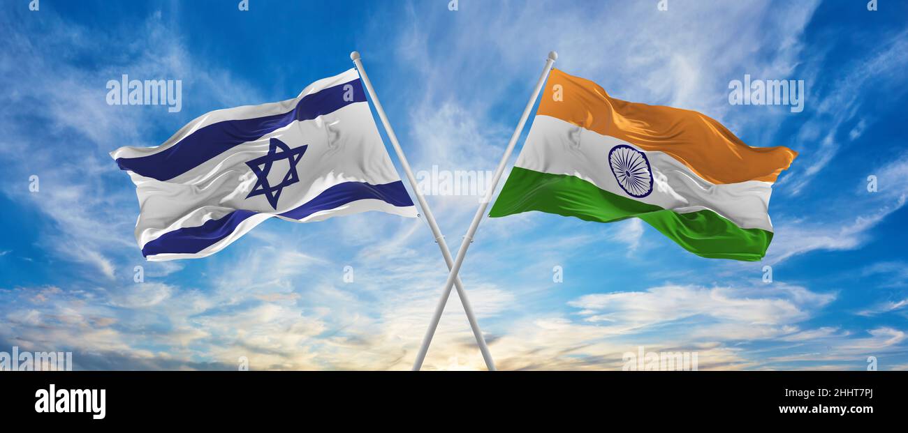 crossed national flags of Israel and India flag waving in the wind at ...