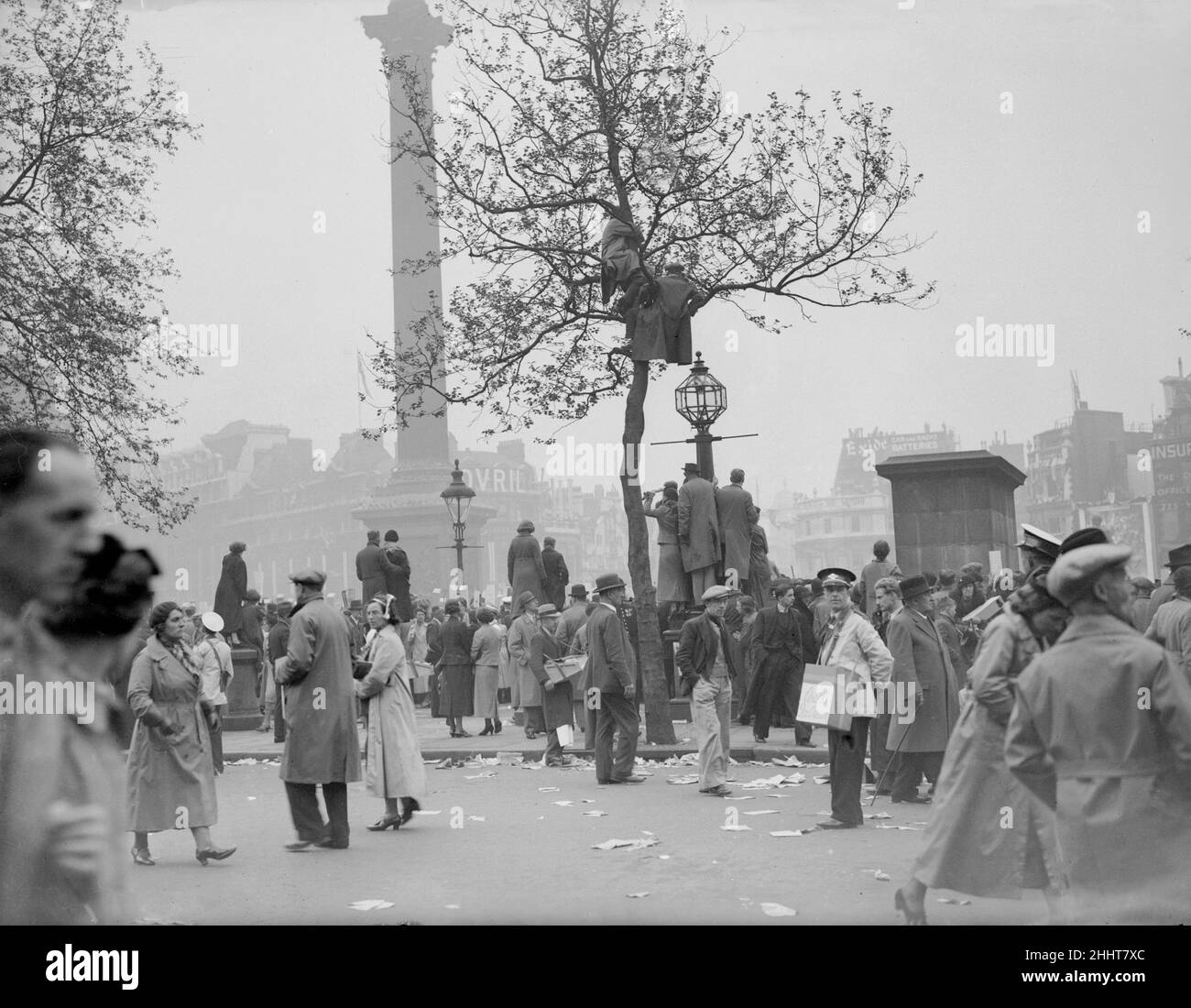 Coronation of King George VI. crowds gathered in Trafalgar Square awaiting the arrival of the procession. Some climb tress to get a better view.  12th May 1937. Stock Photo
