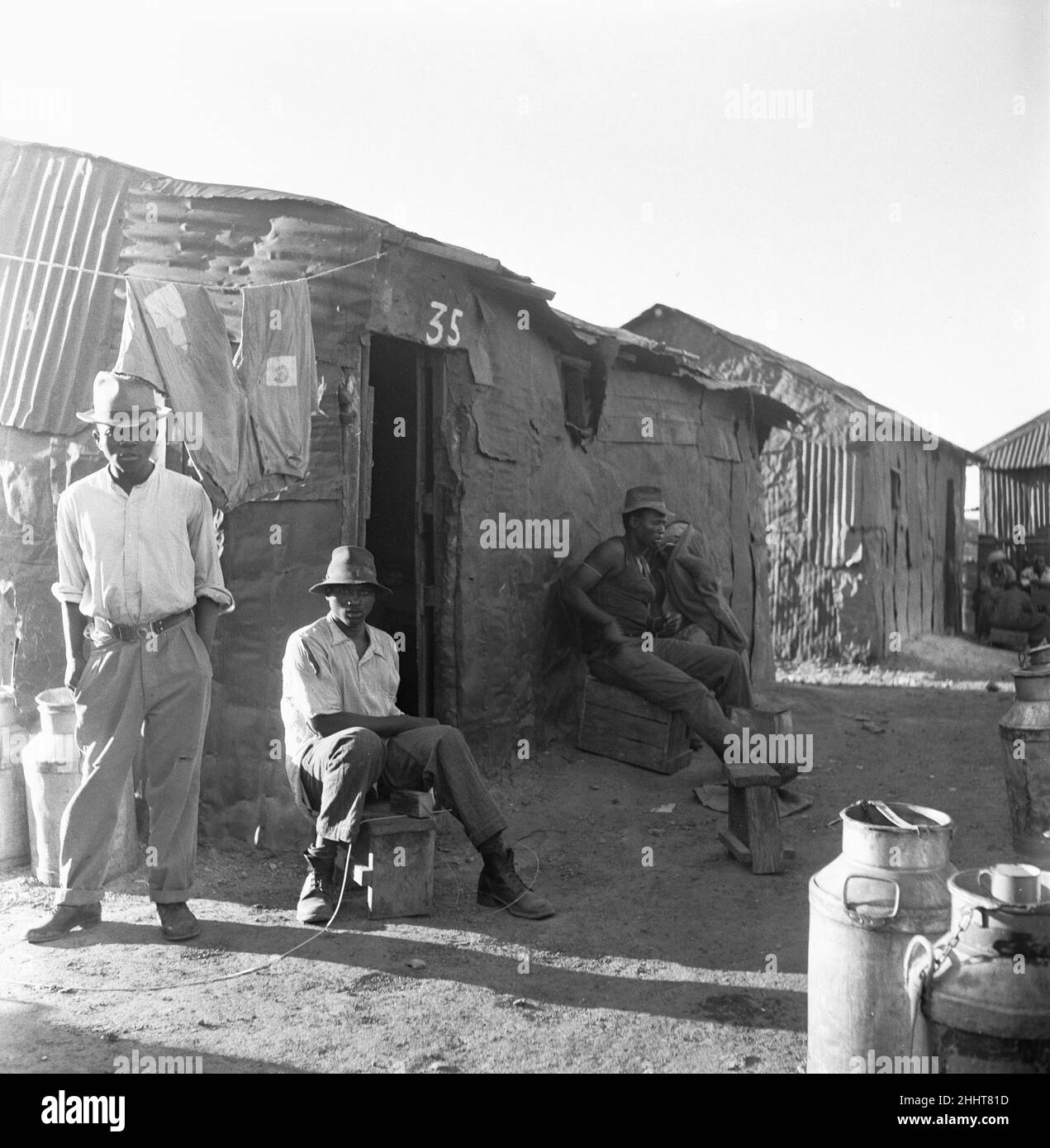 Some of the young men of the Windermere township, eleven miles from Cape Town. 4th February 1955Thousands of it's young men are not allowed into the city. They would be arrested if they came into the city without a pass and they have a nothing to do, so they rot.  They are not allowed to work and they have nowhere to go and not enough to eat Stock Photo