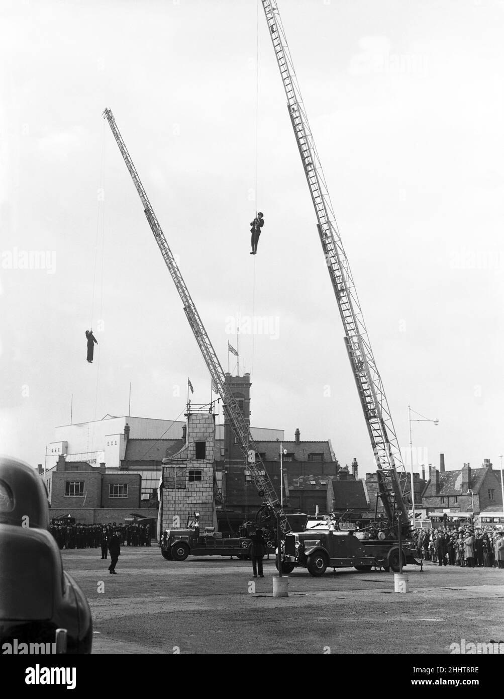 The Fire Brigade seen here giving a demonstration of their extendable ladders at their Pool Meadow fire station. Coventry, West Midlands, Circa 1950 Stock Photo