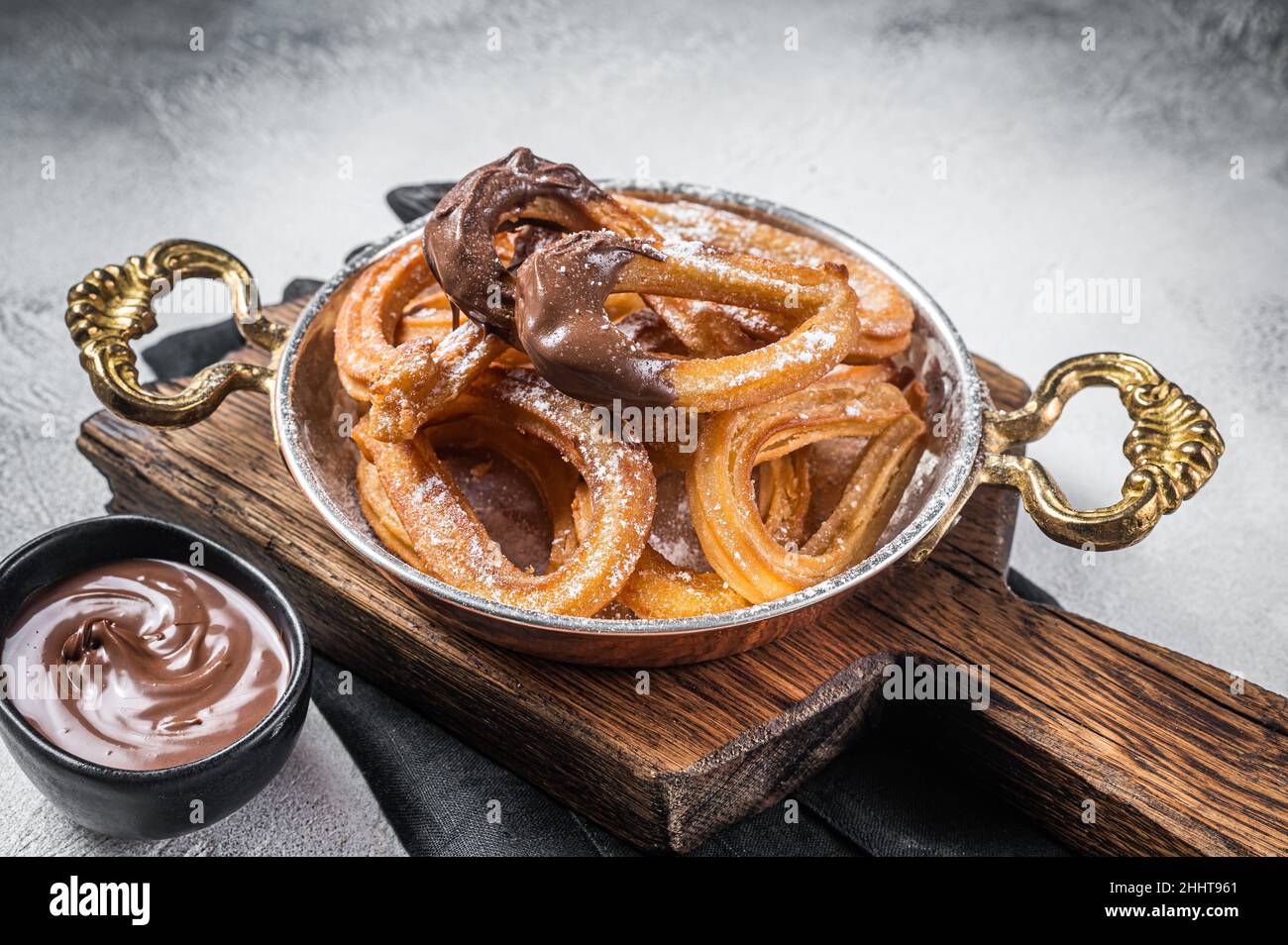 Churros con chocolate typical Spanish sweet snack in a skillet. Gray background. Top view Stock Photo