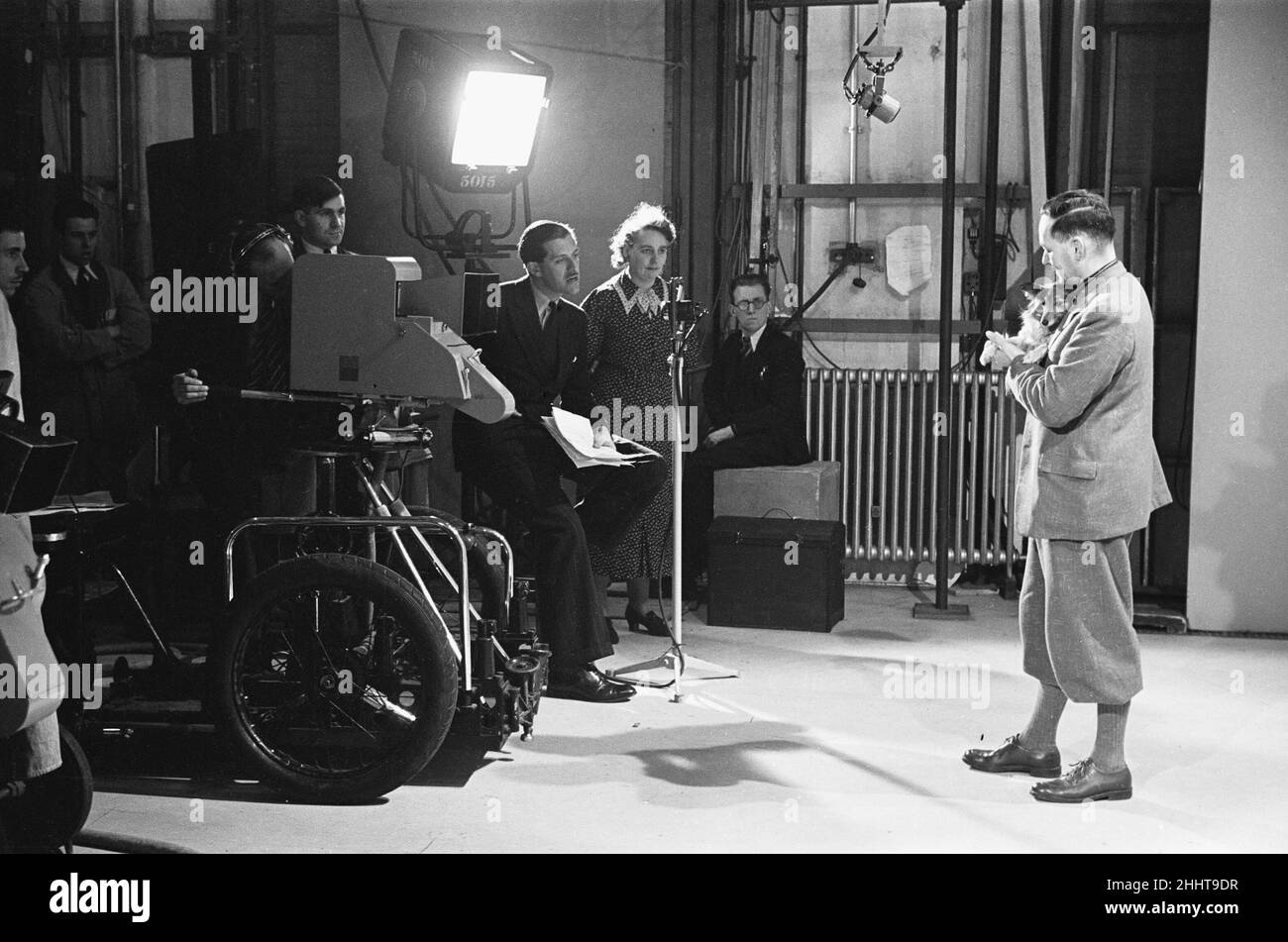 Picture Page television magazine programme seen here being broadcast from the BBC studios at Alexandra Palace. January 1939. Our picture Shows: Presenter Leslie Mitchell off camera seen here interviewing one of the guest in the studio. Stock Photo