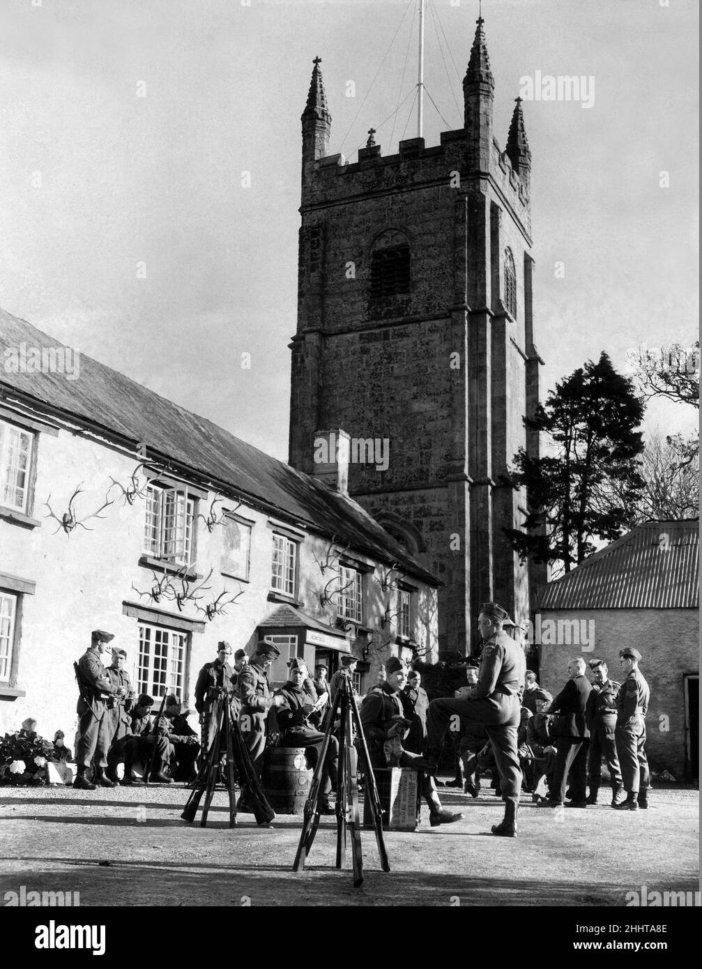The 400 year old antique Royal Oak Inn, nestling under the rustic shadow of the village church in Pillaton, was the place of parade for the last 'Fallin' of the Pillaton G Platoon' Number 2 Company Home Guard formed exclusively of farmers. The Guards are pictured having a drink and chat before breaking up after they 'fell out'.  29th October 1944. Stock Photo
