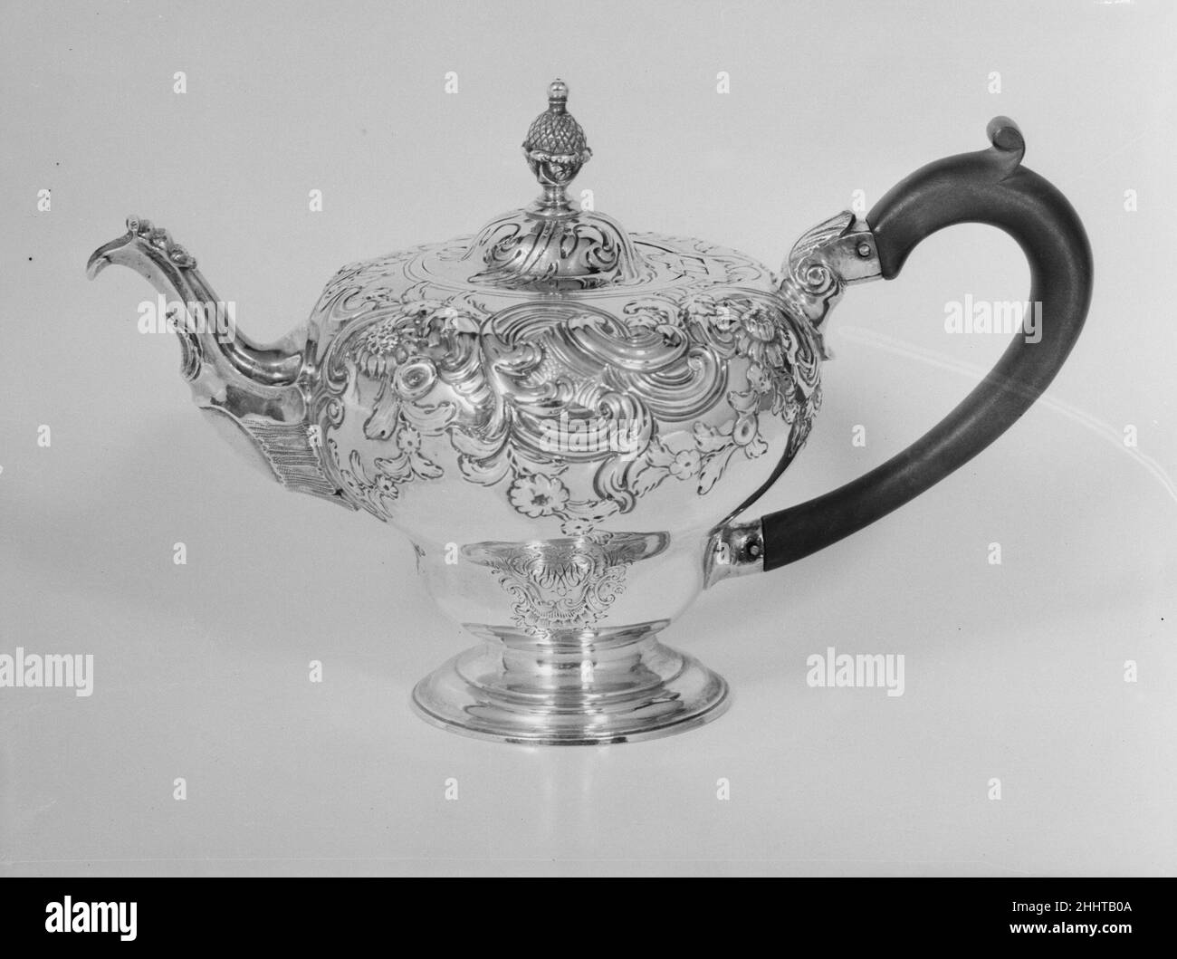Teapot 1753–54 Thomas Whipham British Repoussé decoration was achieved by hammering silver from the inside to create brilliant, raised textural effects on the outside. Silver vessels in inverted pear shapes were popular in the mid-eighteenth century, and the asymmetrical arrangement of flora and fauna seen here is typical of the Rococo style.. Teapot. British, London. 1753–54. Silver. Metalwork-Silver Stock Photo