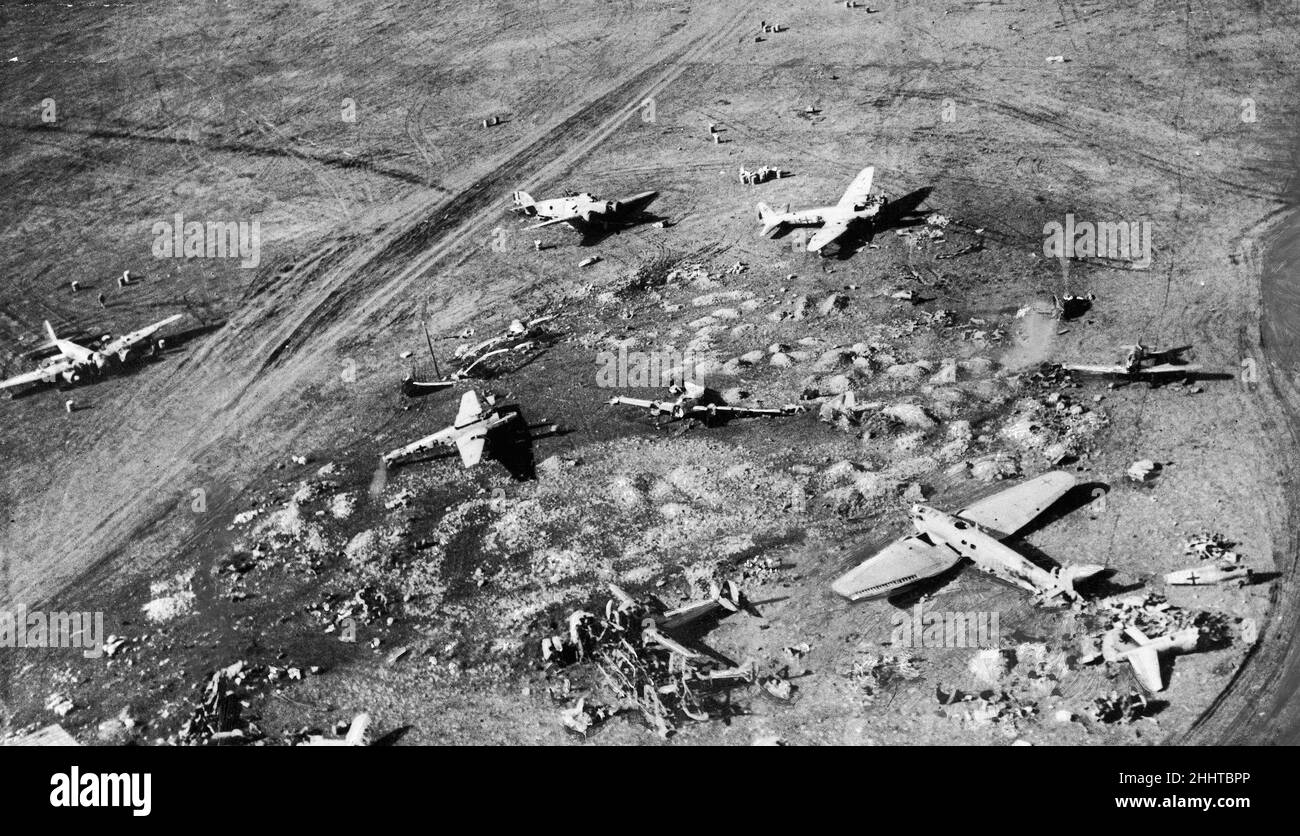 Damaged enemy aircraft and workshops at derna Aerodrome.This picture shows how the aerodrome looked after RAF had visited it. January 1942 Stock Photo