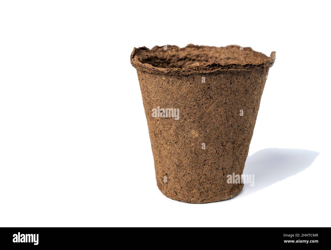 an empty peat pot for seedlings isolated on a white background. Stock Photo