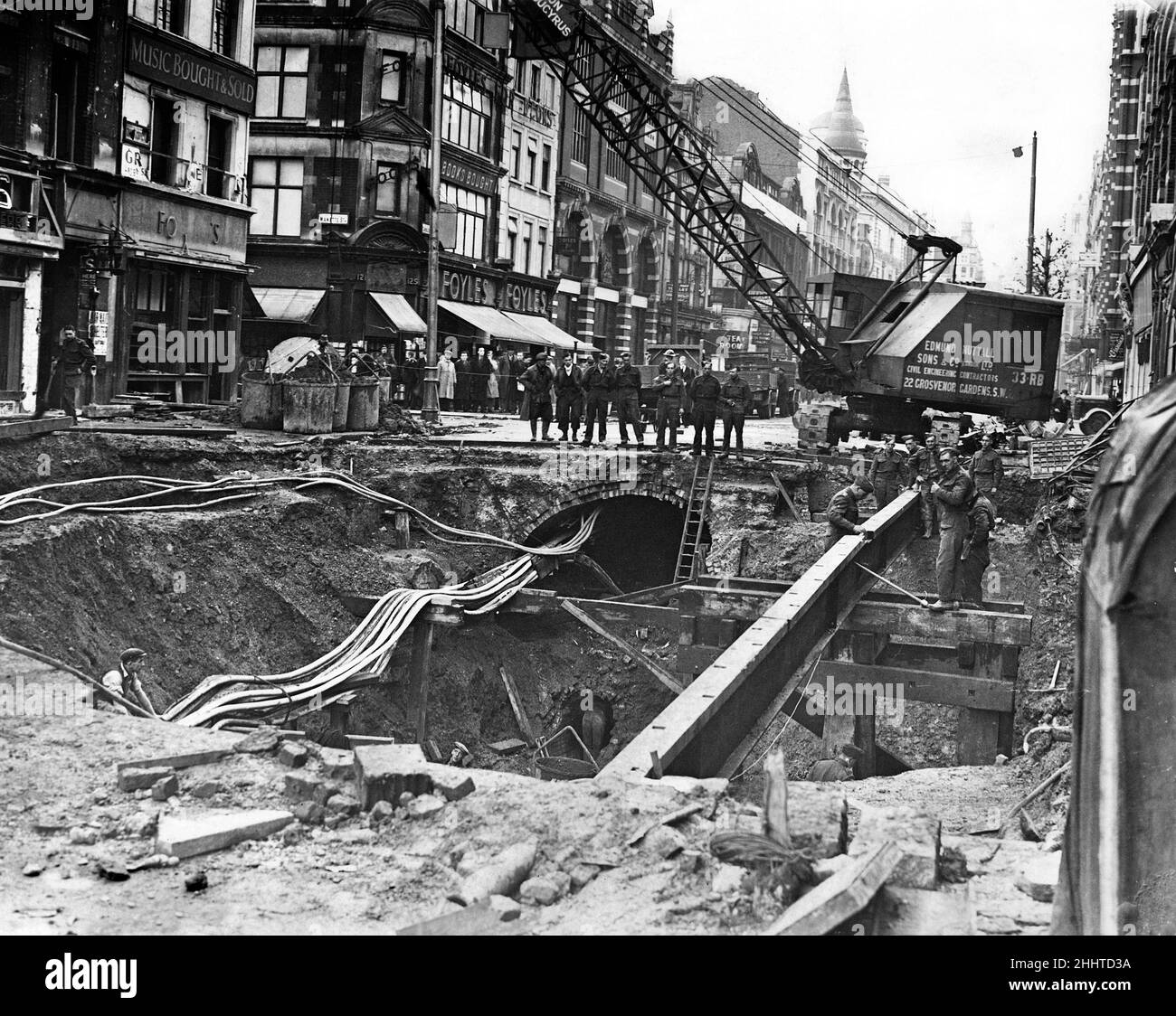 Bomb damage being repaired on The Charing Cross Road, near St
